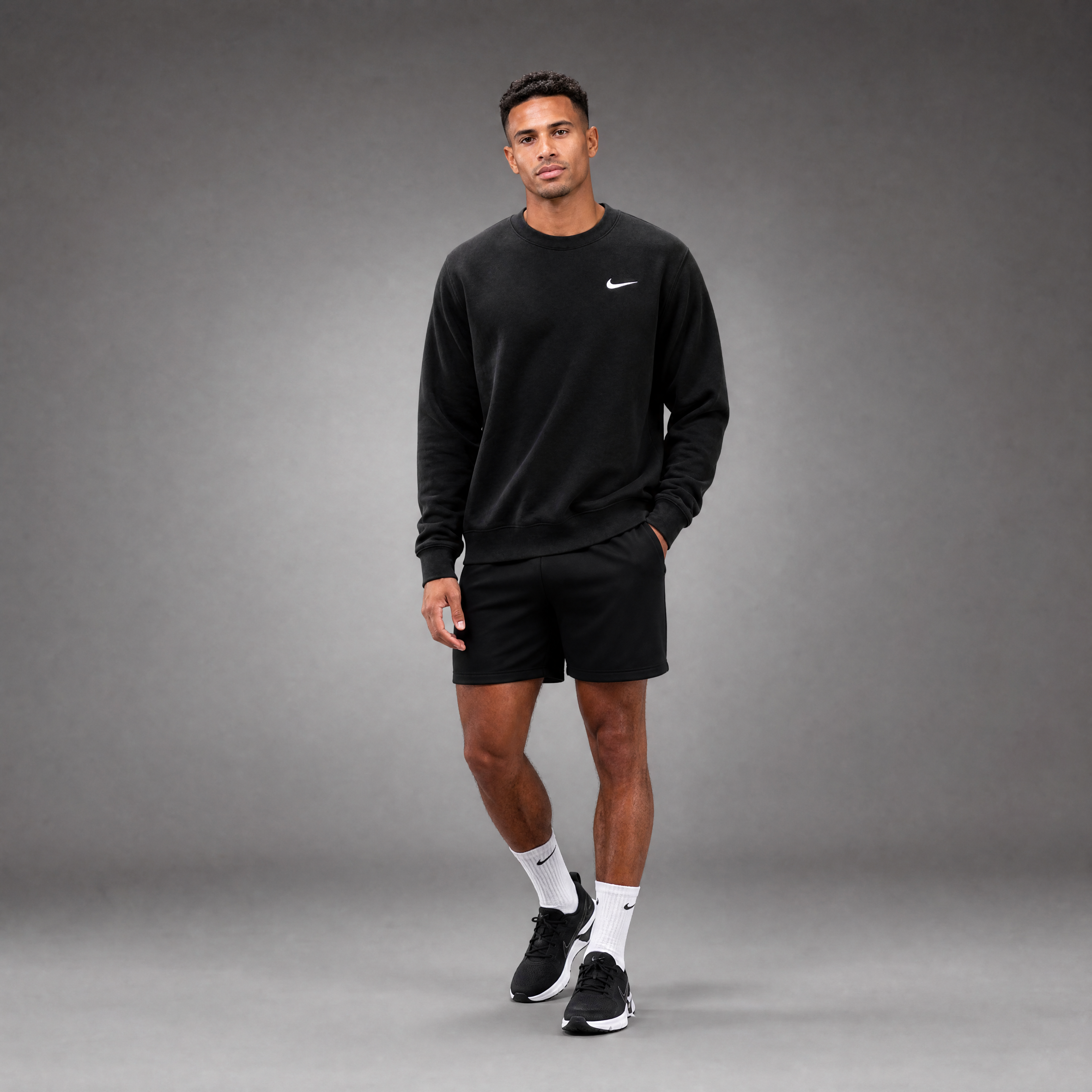 Male athlete modeling the black FCTR Apparel Nike Men's Club Fleece Crew