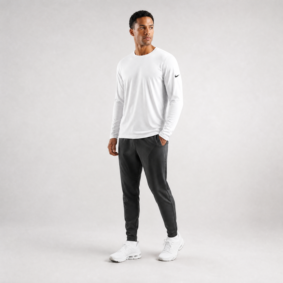 Male athlete modeling the white Nike Cotton Long Sleeve Men's Tee