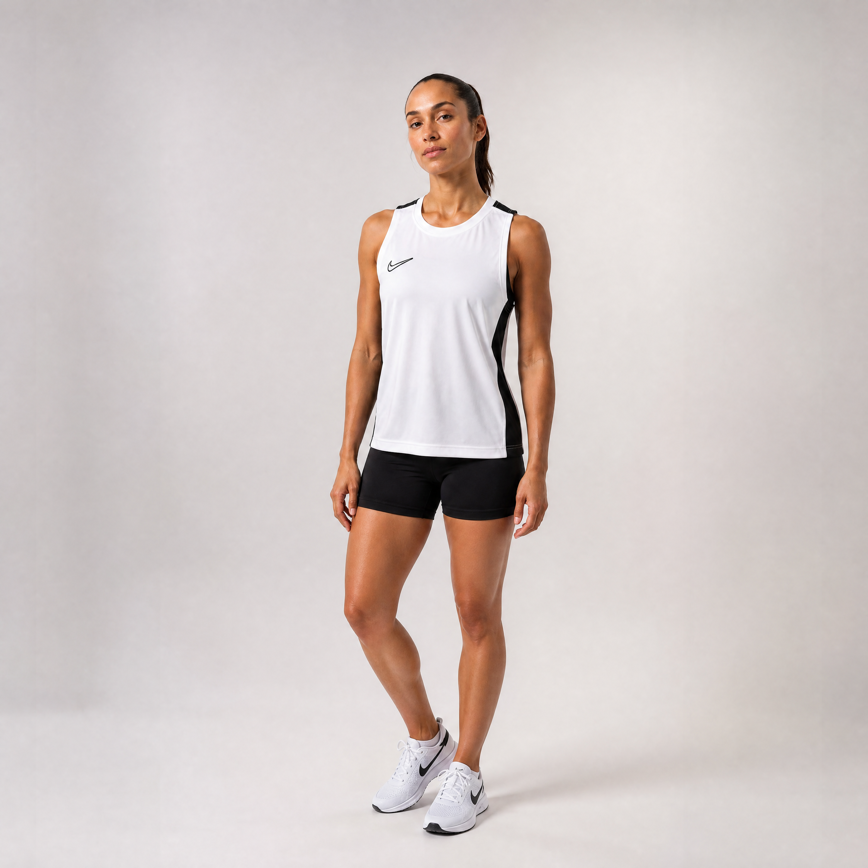 Female athlete modeling the white Nike Dri-FIT Academy 23 Sleeveless Soccer Top
