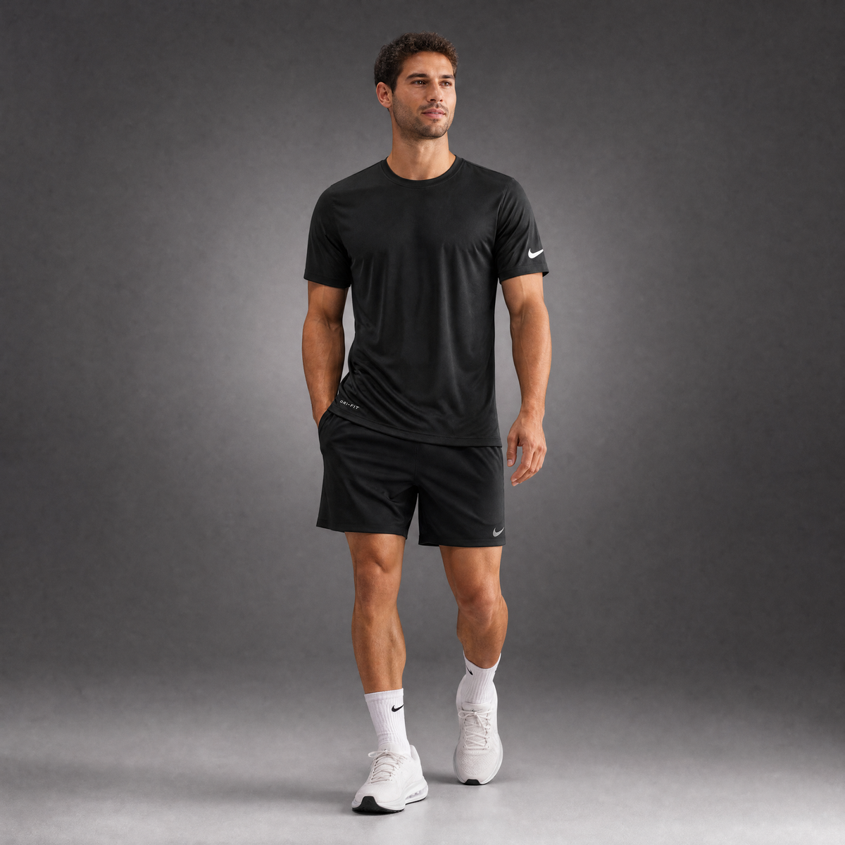 Male athlete modeling the black Nike Cotton Short Sleeve Men's Tee