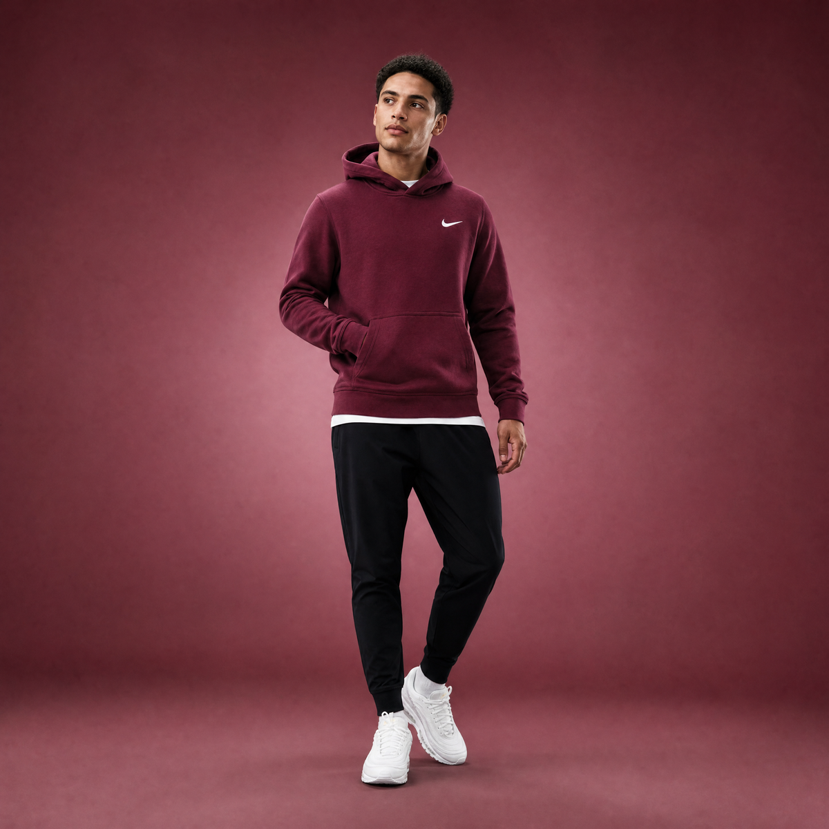 Male athlete modeling the maroon FCTR Apparel Nike Club Hoodie