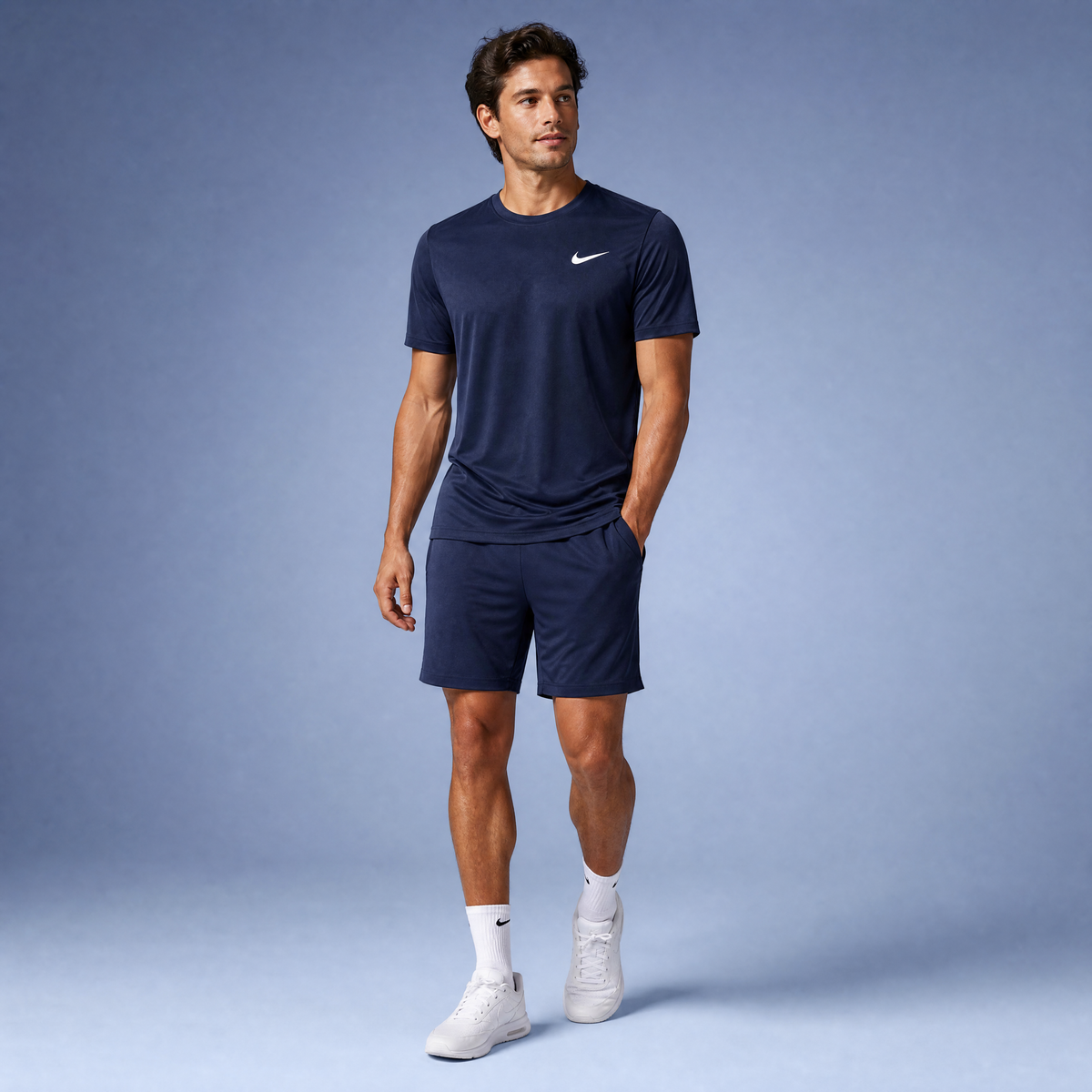 Male athlete modeling the navy Nike Short Sleeve Dri-FIT Athletic Shirt