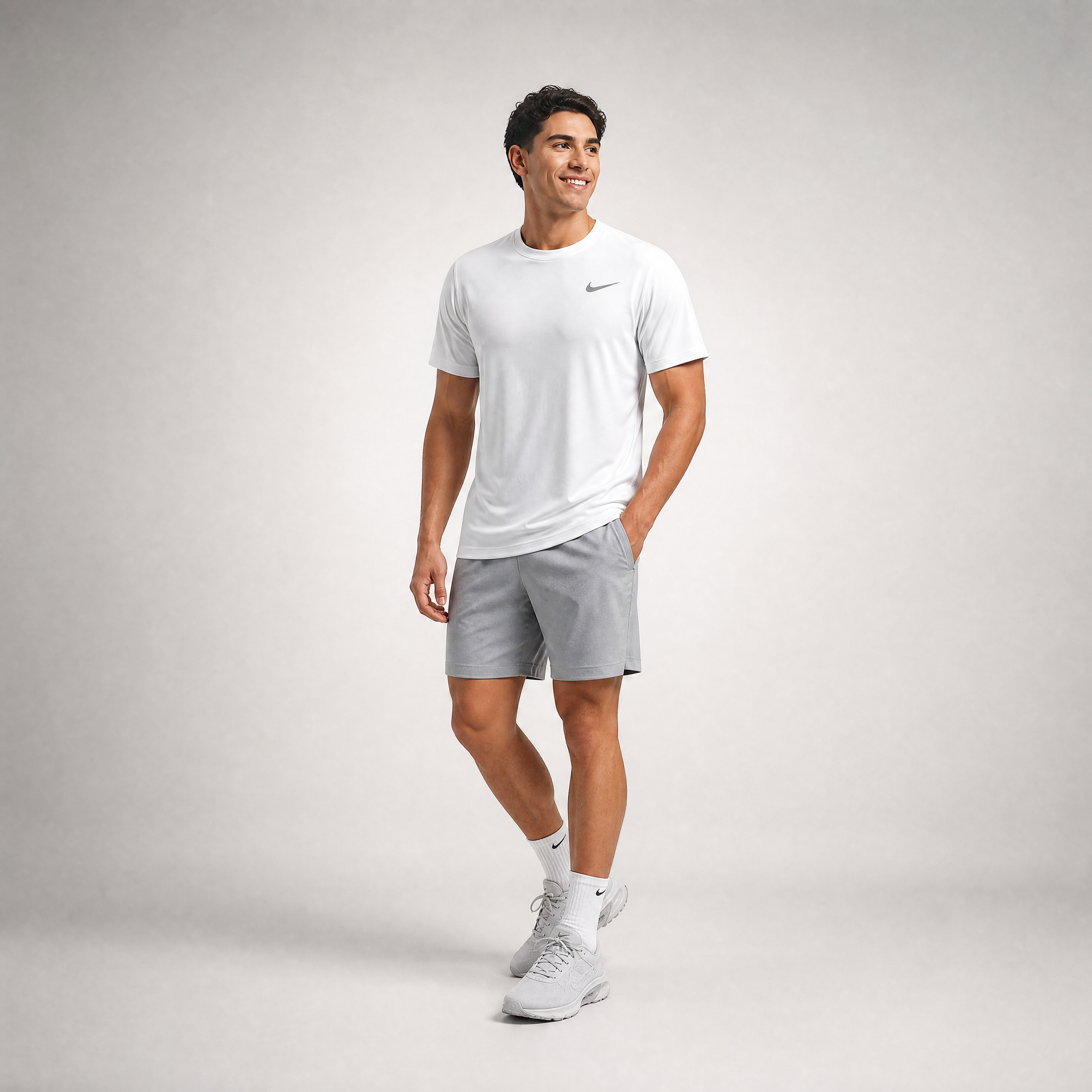 Male athlete modeling the white Nike Short Sleeve Dri-FIT Athletic Shirt