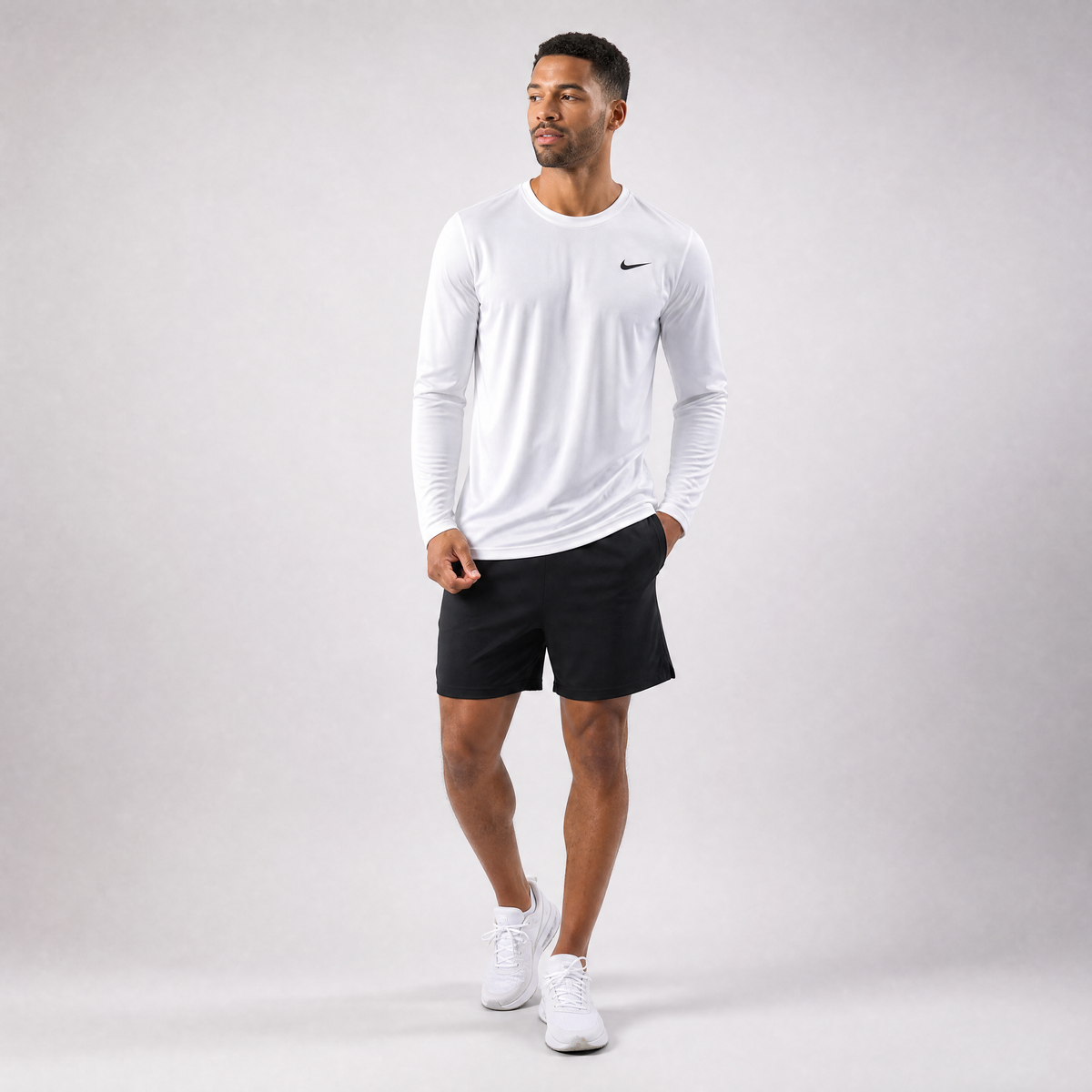 Male athlete modeling the white Nike Long Sleeve Dri-FIT Athletic Shirt