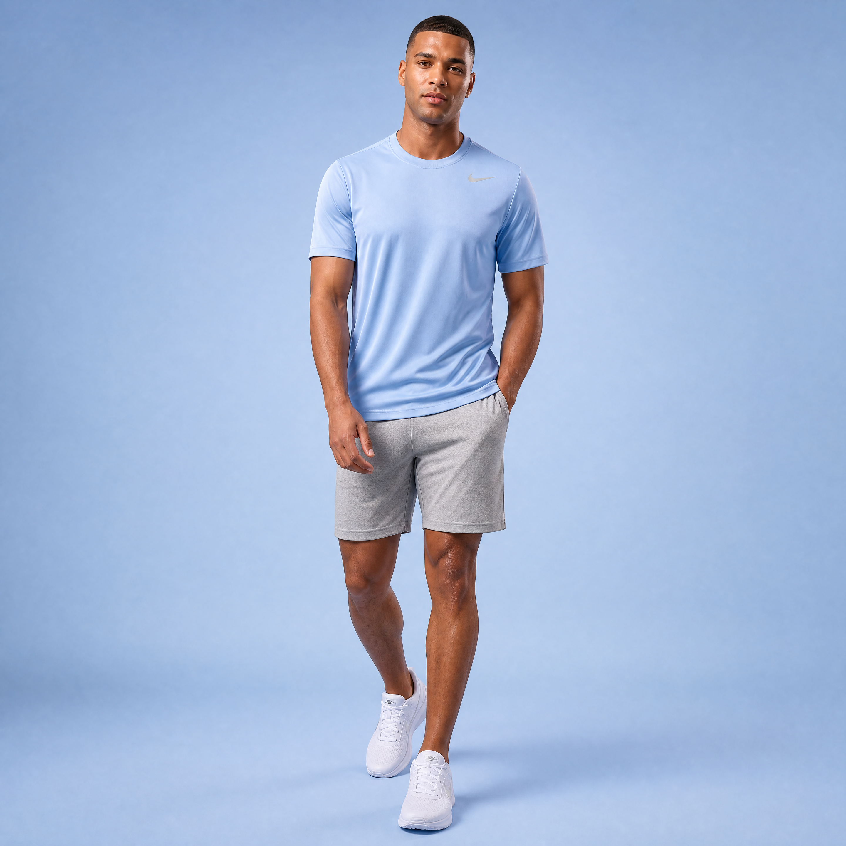 Male athlete modeling the light blue Nike Short Sleeve Dri-FIT Athletic Shirt