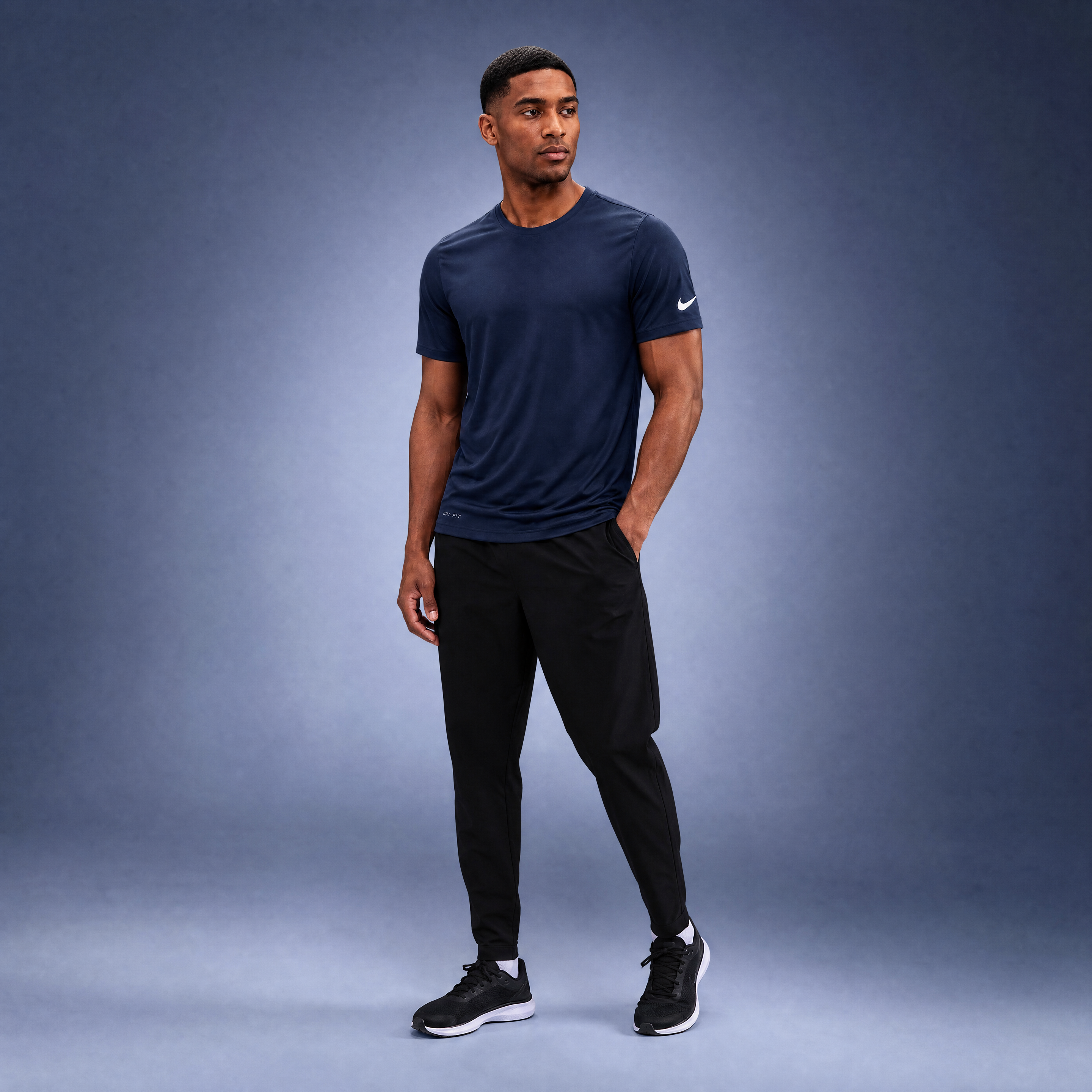 Male athlete modeling the navy Nike Cotton Short Sleeve Men's Tee