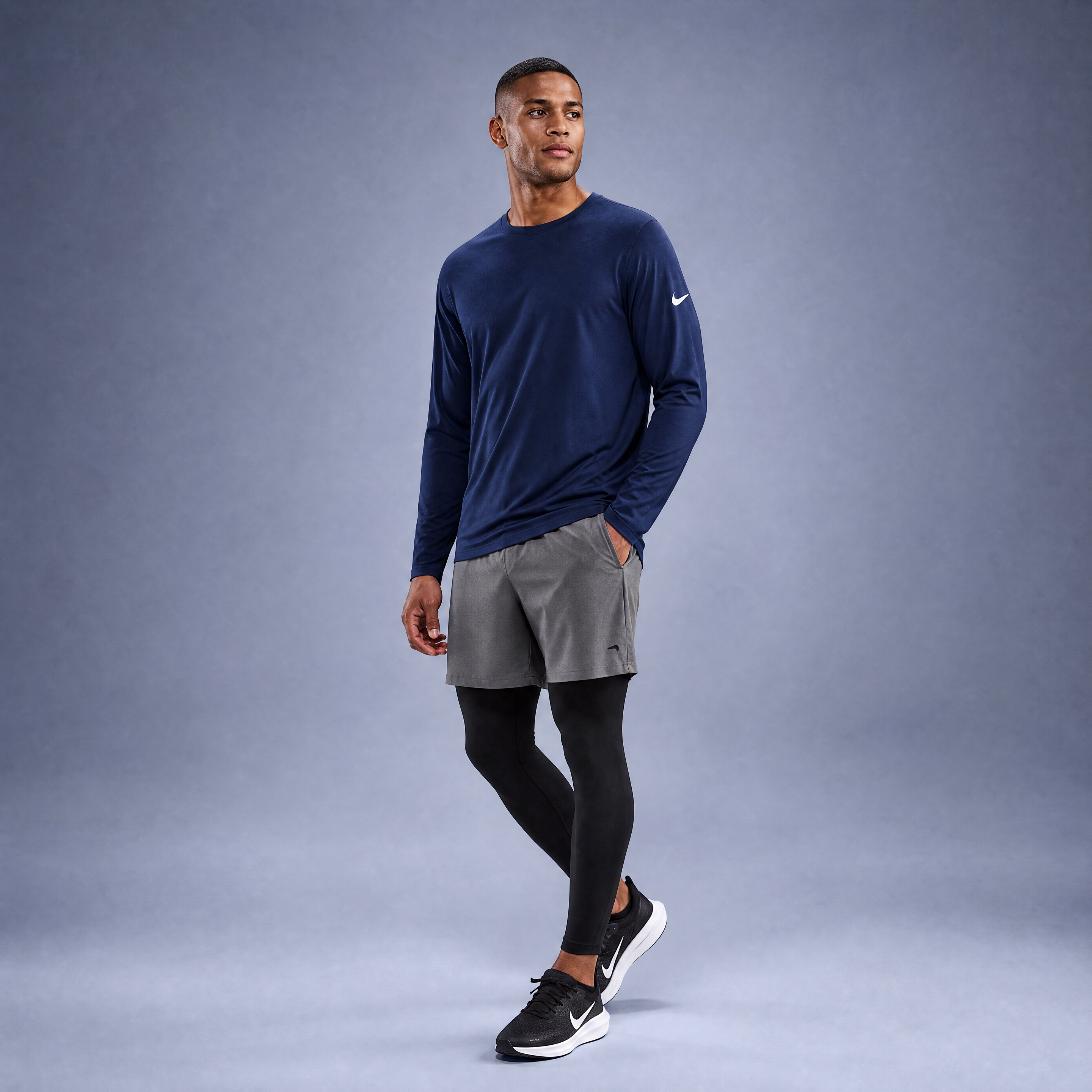 Male athlete modeling the navy Nike Cotton Long Sleeve Men's Tee