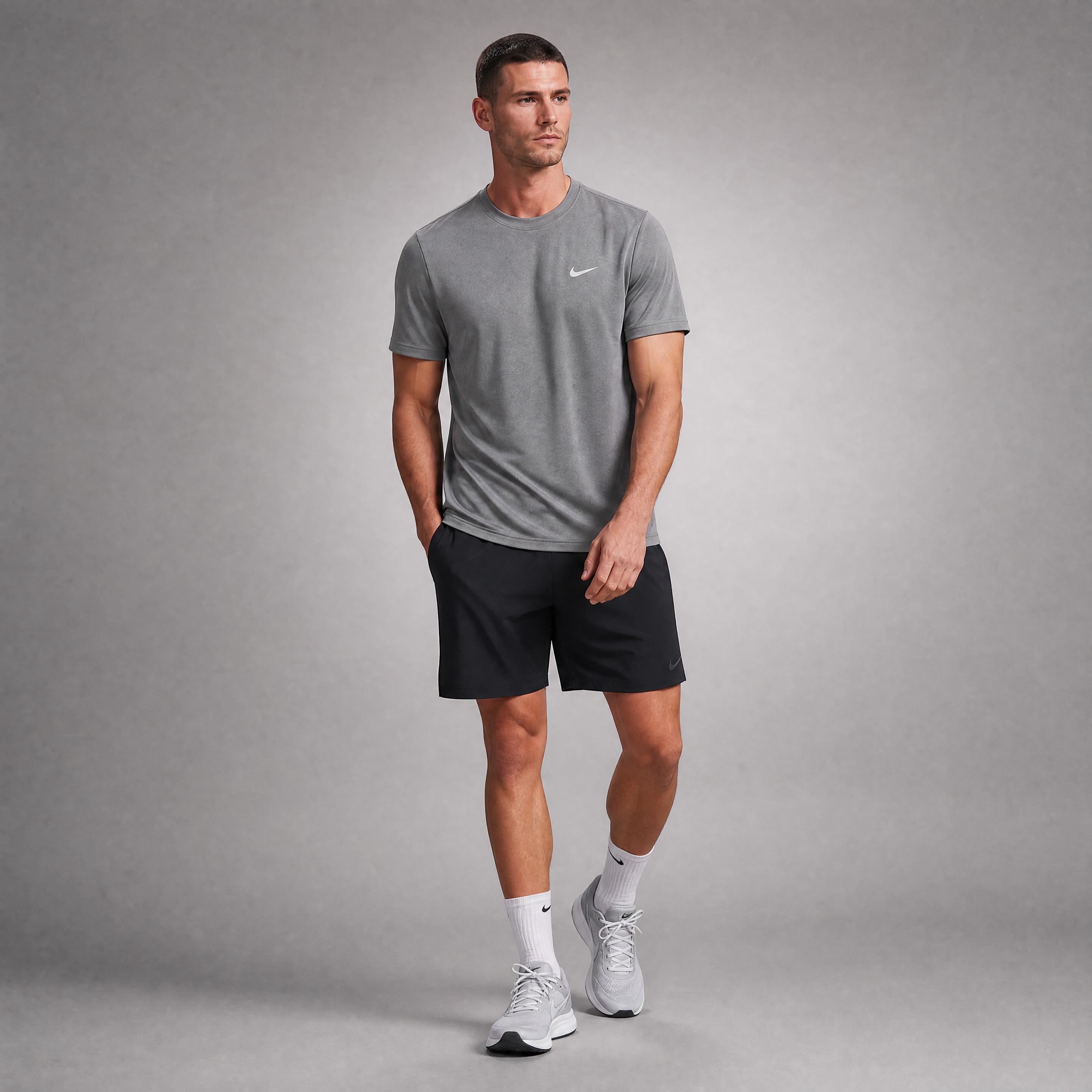 Male athlete modeling the gray Nike Short Sleeve Dri-FIT Athletic Shirt