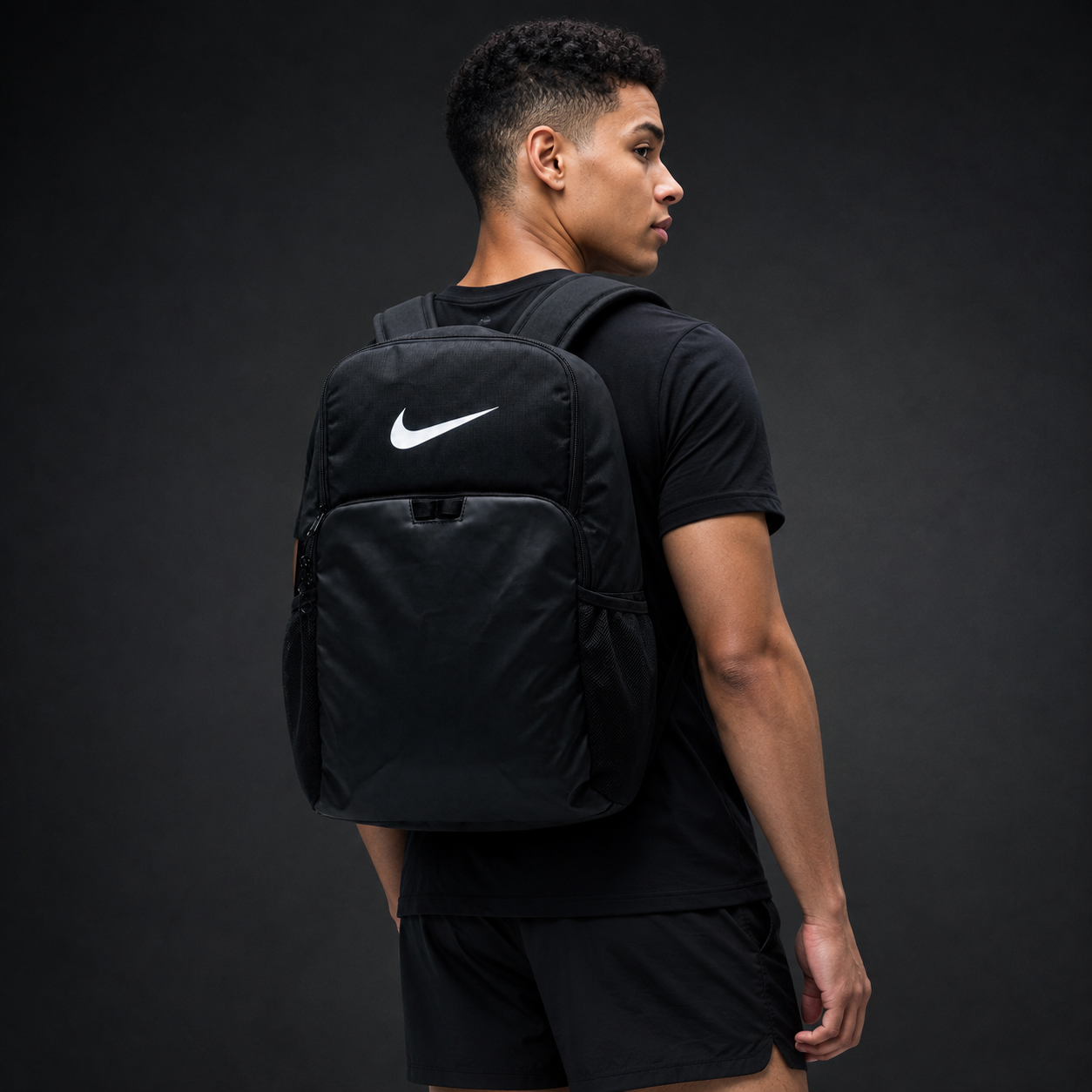 Athletic model wearing the black FCTR Apparel Nike Backpack